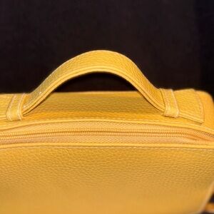Woman’s Estee Lauder Yellow Leather Top-Handle makeup Bag